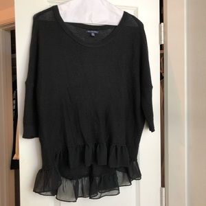 Black knit sweater with hem ruffle
